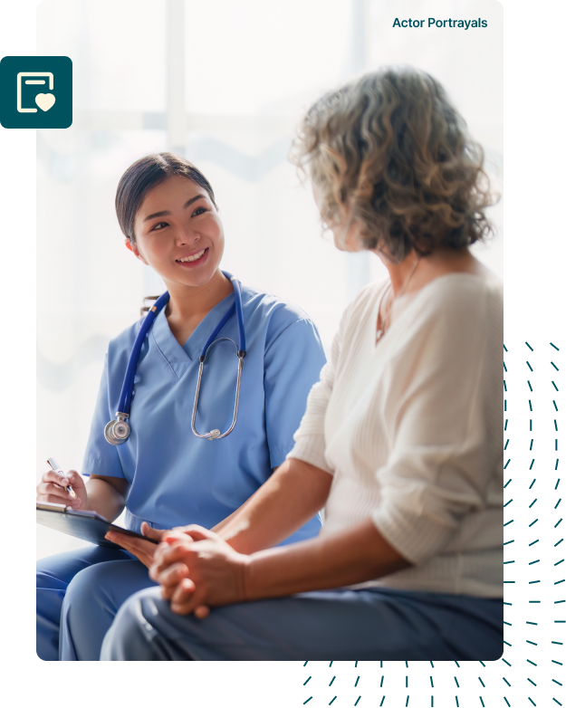 A doctor wearing a white lab coat smiling warmly at a patient seated in front of them, conveying empathy and reassurance during a medical consultation.